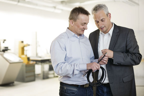 Zwei Männer prüfen ein Kabel