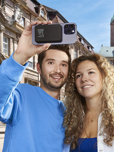 Couple taking a selfie in front of a city skyline