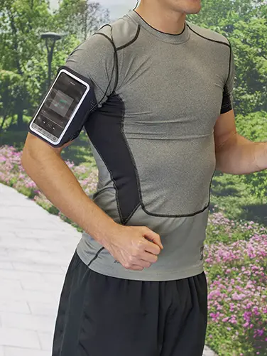 Person wears sports armband while jogging.