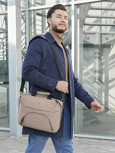 Geschäftsmann trägt die Hama Laptop-Tasche "Premium Lightweight" über der Schulter auf dem Weg zum nächsten Meeting