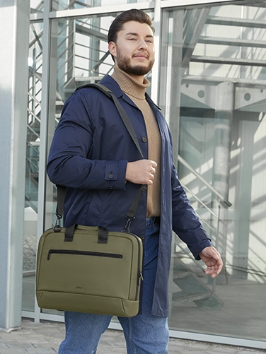 Businessman carries the Hama "Ultra Lightweight" laptop bag over his shoulder on the way to the next meeting