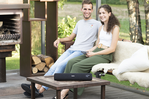 Couple sitting on garden bench listening to music through Hama Bluetooth® speaker "PipeRoll 3.0