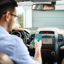 Man in car opens garage door with mobile phone