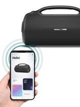 Cell phone in hand in front of black speaker